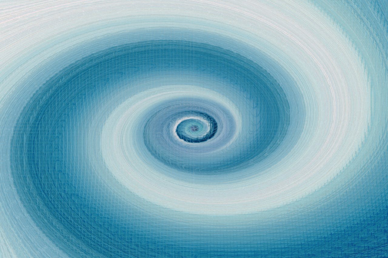 Abstract blue spiral image exuding dynamic energy and motion in vibrant shades.